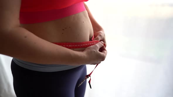 Close Up Frustrated Overweight Woman Measuring Waist