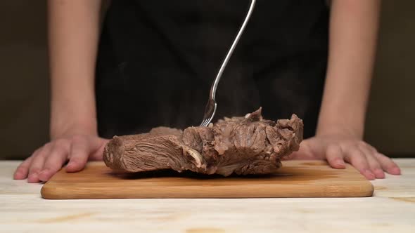 Woman chooses boiled hot meat instead of fresh vegetables. Close up