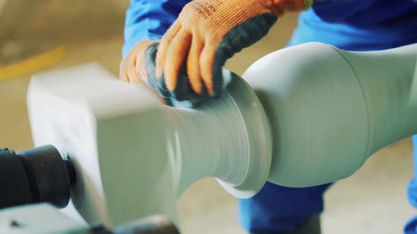 The master works with a stone using a grinder. Polishing and grinding stone on the machine.