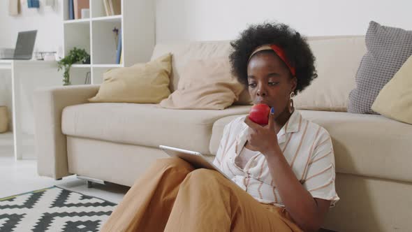 African American Woman Working on Digital Tablet from Home