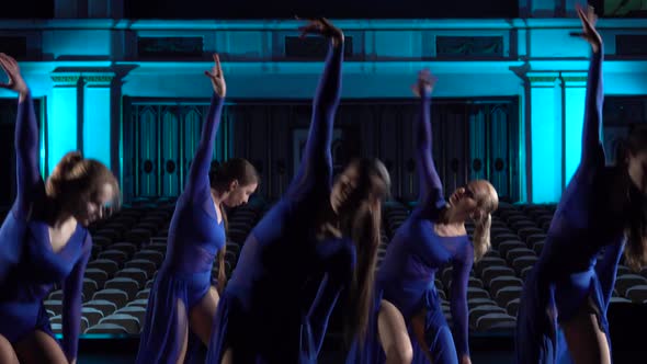 Group Young Skillful Ballerinas Dancing Modern Ballet on the Stage of Large Hall. Girls Looking at