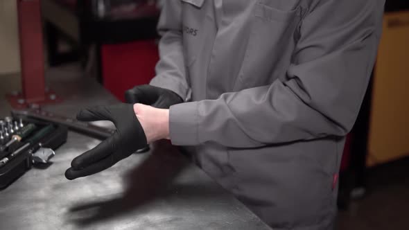 Mechanic Man Wears Black Leather Gloves