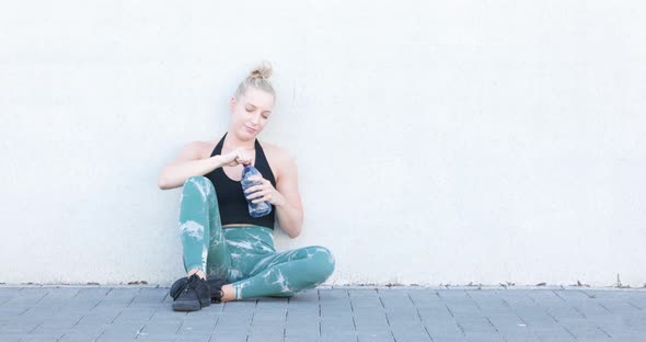 Sport and Lifestyle Concept Sporty Blonde Woman Resting After Doing Sports Outdoors