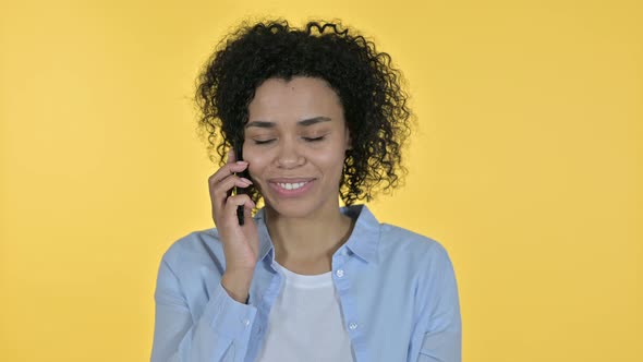 Portrait of Cheerful Casual African Woman Talking on Smartphone