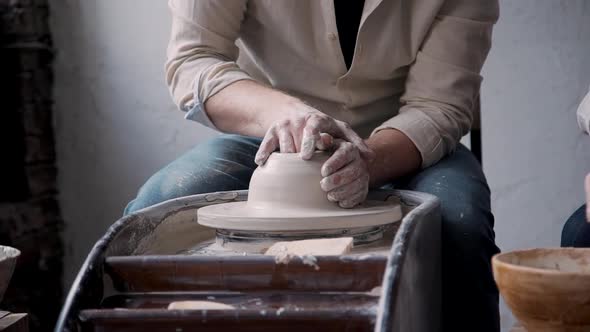 Adult Sculptor Making Earthenware Objects in Studio