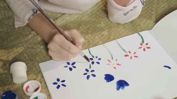 Girl Drawing Glade with Colorful Flowers with Gouache, Painting Her Mood, Art