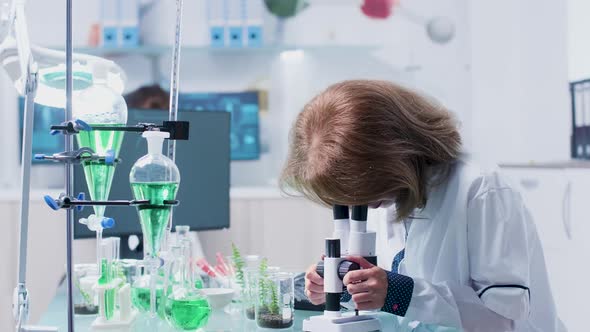 Woman Researcher Uses a Microscope