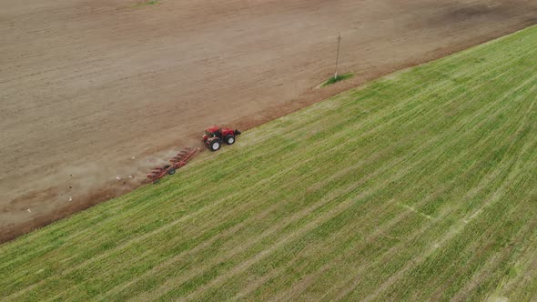 Tractor with Working Plow From a Drone POV