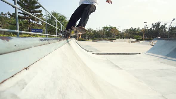 Skater Sliding On Skatepark Ramp