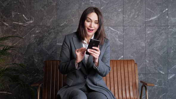 Young Woman with Short Dark Hair Types on Black Smartphone