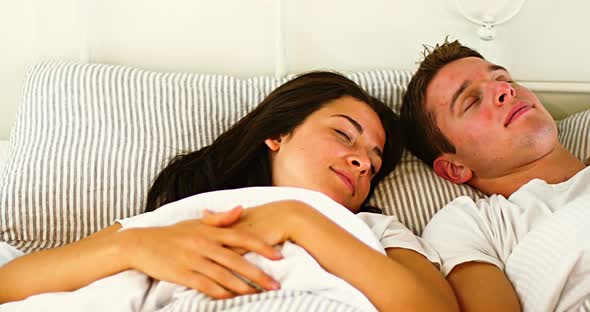 Couple sleeping in bedroom