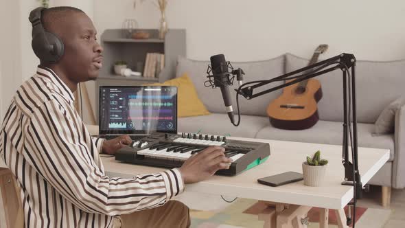 African Man Creating Music Using Home M-audio Keystation