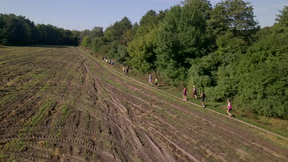 Aerial Shot of People in Trail Running Marathon in a Countryside Field Road, Slow Motion  60 Fps