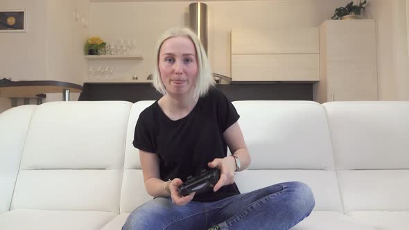 Blond Teenage Girl Passionately Plays Video Games after School