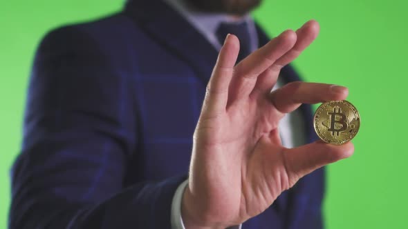 Young American Entrepreneur Holding Gold Bitcoin in Hand Standing in Investment Company