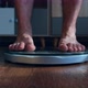 Person Male Measures the Body Weight Loss Standing on the Scale in the Living Room - VideoHive Item for Sale