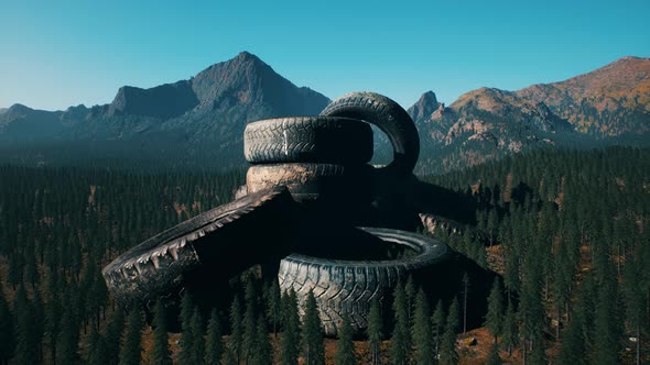 Concept of Environmental Pollution with Big Old Tires in Mountain Forest alt