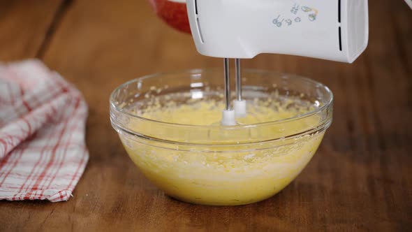 Adding flour to the dough, Mixing dough in bowl with motor mixer