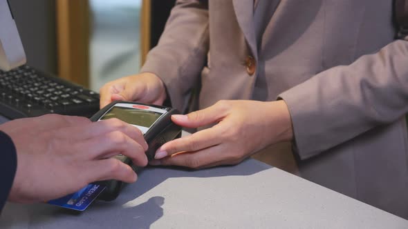 Hands of businessman holding credit card shopping and paying with contactless.