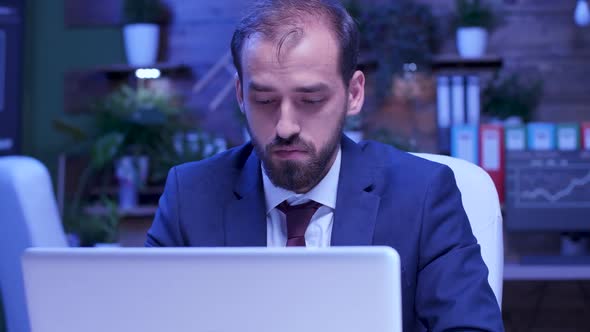 Close Up Shot of Tired and Exhausted Businessman Working Late Night