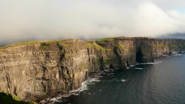 Aerial Ascending Footage of Rocky Shore Lit By Bright Sun