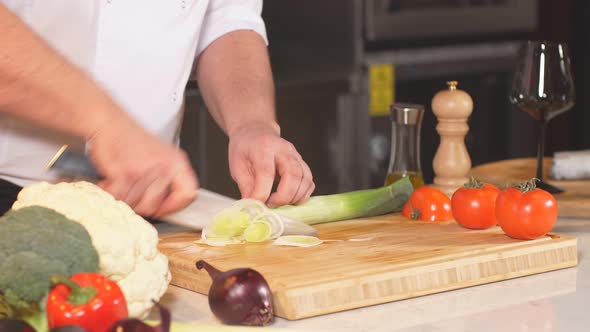 Close-up of a Chef Masterfully Cutting Colorful Vegetables on Cutting Board. Tomatoes and Mushrooms