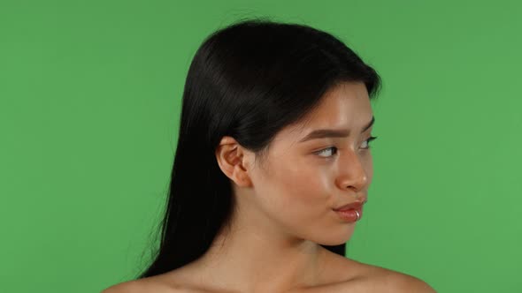 Beautiful Asian Woman Looking To the Sides, Then Smiling To the Camera