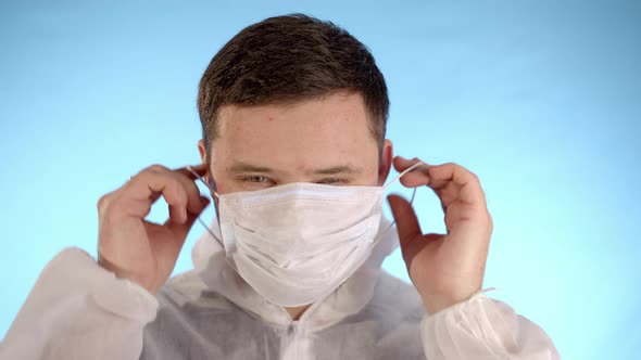 Caucasian Man in White Protective Suit Look at Camera