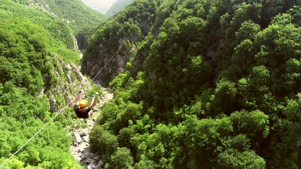 Aerial view of person zip-lining in Soca valley, Slovenia.