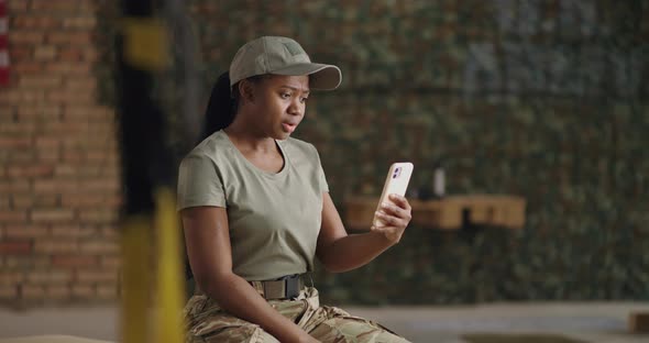 Happy African American Military Woman Making Video Call in Gym