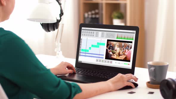 Woman with Video Editor Program on Laptop at Home