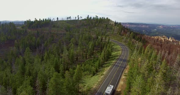 Aerial video of a white caravan driving along a highway (Zion National Park, Utah, USA)