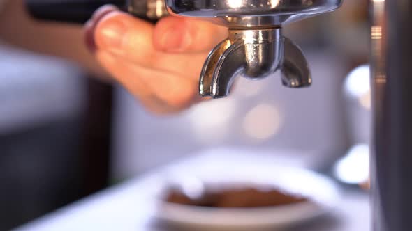 Barista Putting Portafilter in Coffee Machine for Making Espresso