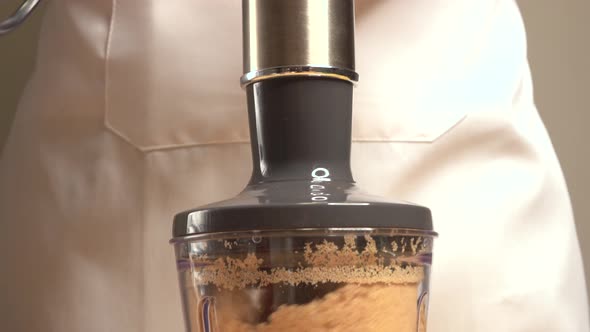 Mixing cookies in a mixer to make a vertical panoramic cake base