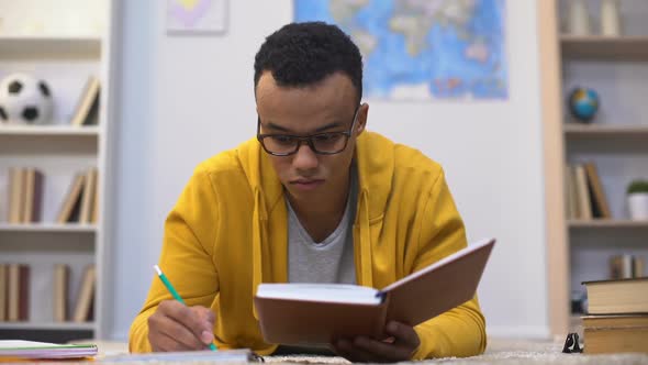 Afro-American Student Writing Essay, Preparing for Important Lectures in College