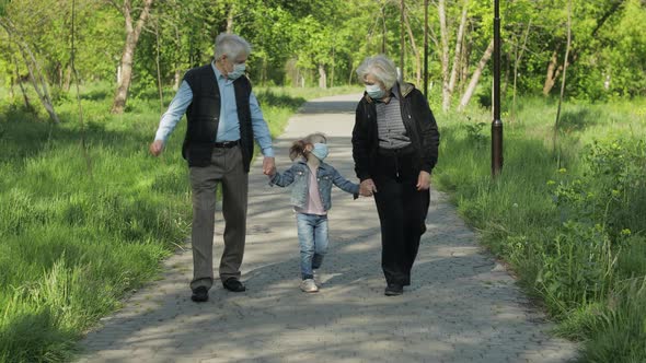 Grandparents with Granddaughter Takes Off Masks After Coronavirus Quarantine End