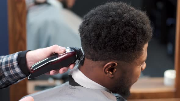 Young Africanamerican Man Visiting Barbershop for Haircut