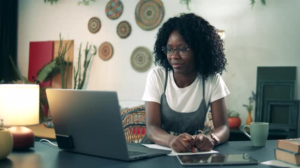 African-american Woman Is Using a Computer for Calling From Home During Covid-19 Pandemic.