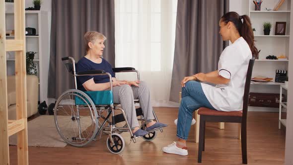 Nurse Checking on Retired Handicapped Old Woman