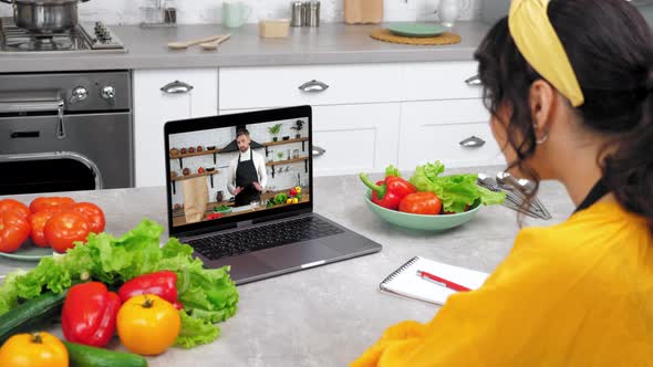 Man Chef Food Blogger in Computer Screen Tells Teaches Housewife Culinary Lesson