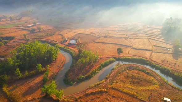 Aerial view from a drone over misty landscape on farmland. 4K