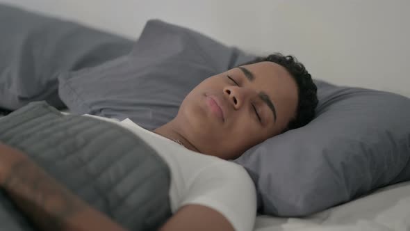 African Woman Having Headache While Sleeping in Bed