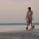 Stylish Lady Walking with Her Cute Pet on Sea Beach on Autumn Evening Spbi - VideoHive Item for Sale