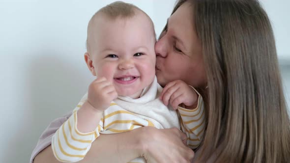 Little Infant Child Laughing Having Fun and Looking in Camera