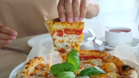 Young Woman Hands Take Pizza Slice and Put on Plate in Cafe