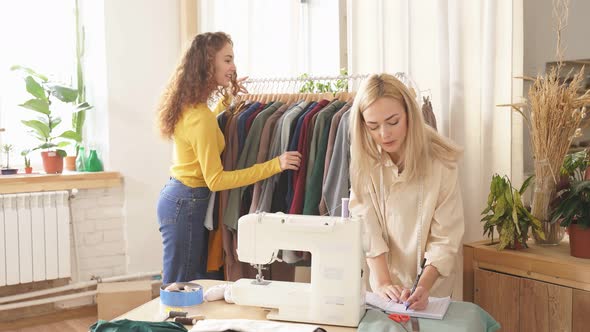 Caucasian Clothing Designer Making Notes While Preparing Tailoring in Design Room Creating New Dress