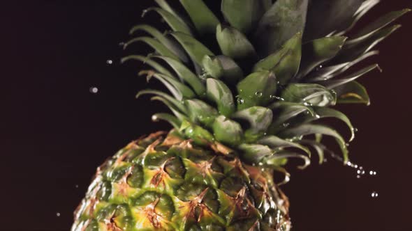 Super Slow Motion Water Drips on Rotating Pineapple