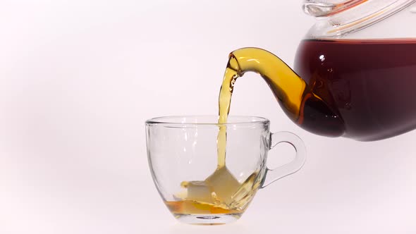 Cup with Two Pieces Sugar Filled Black Tea From Teapot