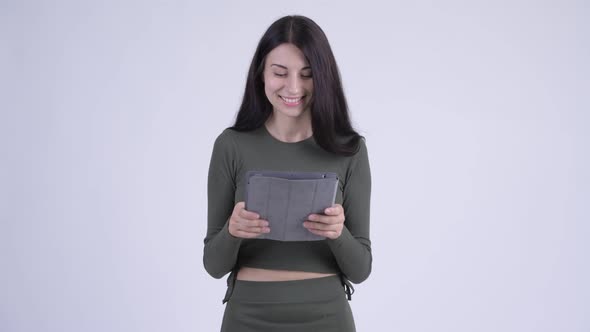 Happy Young Beautiful Woman Using Digital Tablet