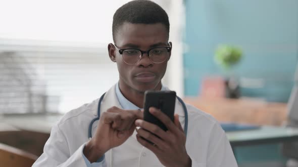 Young African Doctor Using Smartphone
